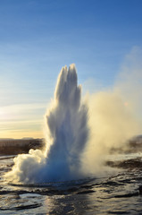 Hot steam erupting from Strokkur fountain geyser located in geothermal area in southwest Iceland...