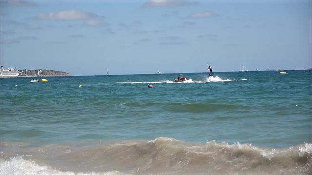 Man doing flyboarding with his flyboard in European beach