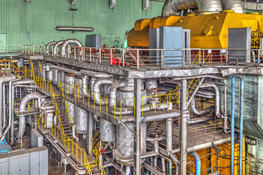 Machine room in thermal power plant with electric generators and turbines