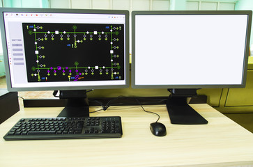 Computers and monitors with schematic diagram for supervisory, control and data acquisition in modern electrical control room