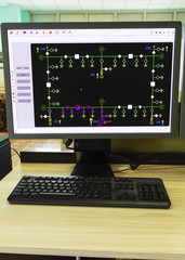 Computers and monitors with schematic diagram for supervisory, control and data acquisition in modern electrical control room