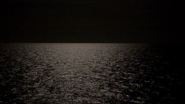 Side deck of cruise ship sailing at sea or ocean in the dark, during the night