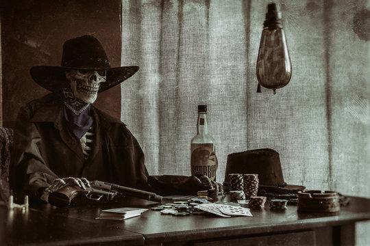 Old West Poker Skeleton Gun. Old west bandit outlaw skeleton at a poker table with a pistol and bourbon, edited in vintage film style.