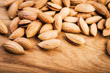 Almonds on wooden background