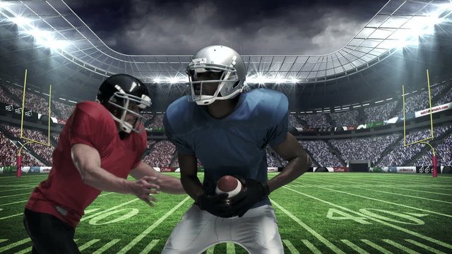 American football player tackling for ball