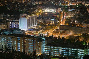 Fototapeta na wymiar Night motion blurred traffic in Athens against the city lights.