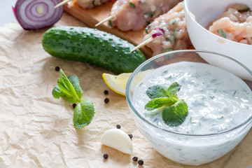 Souvlaki and ingredients, white wood background