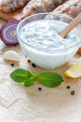 Souvlaki and ingredients, white wood background