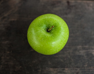 Green apple on a wooden table