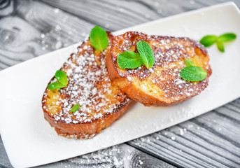 French toast -  fried bread toast with powdered sugar and mint