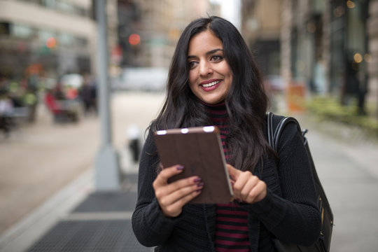 Indian Woman In City Using Tablet Computer