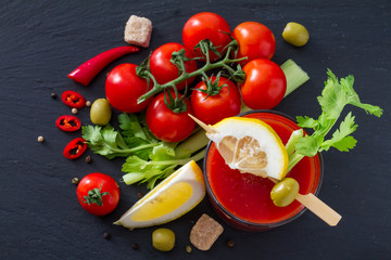 Bloody Mary ingredients on dark stone background