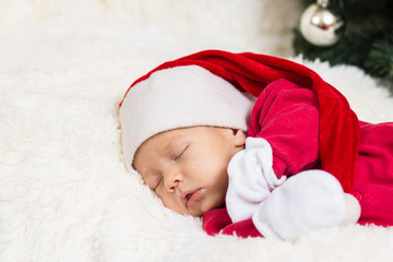 cute baby sleeping in Christmas clothes