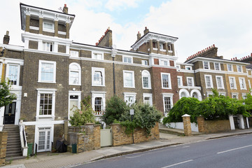 Fototapeta na wymiar English brown bricks houses in London with small tower