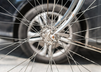 Bicycle versus car. Wheels against each other.
