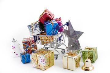 Shopping cart with colorful gift boxes isolated on white backgro