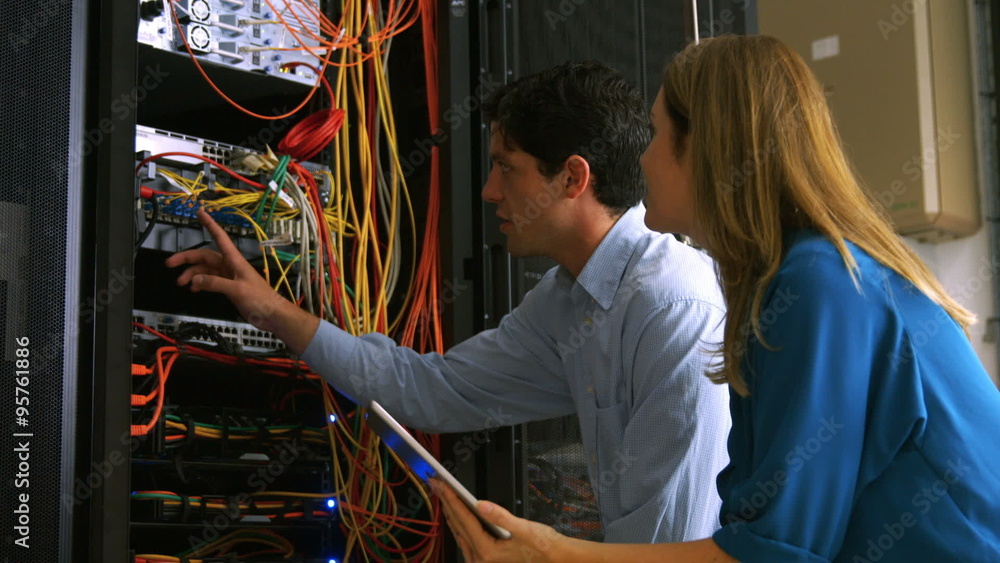 Poster Technician looking at open server locker
