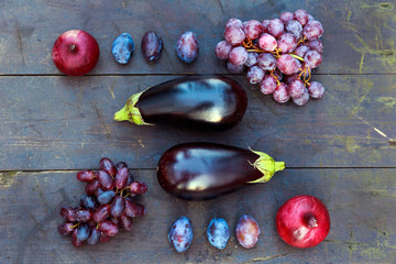Still life in purple colors on a wooden table