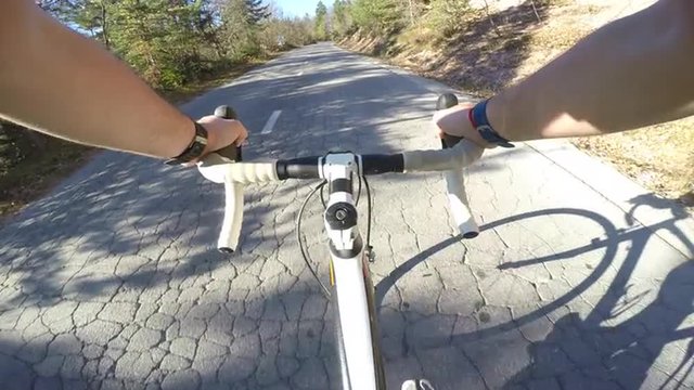 4K POV Road cyclist on asphalt mountain road on a sunny day
