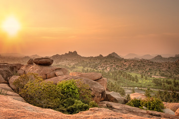 Fototapeta premium Picturesque view from the Malyavanta Hill at sunset overcast sky in Hampi, Karnataka, India.
