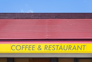 Yellow Coffee and restaurant shop signboard and red roof