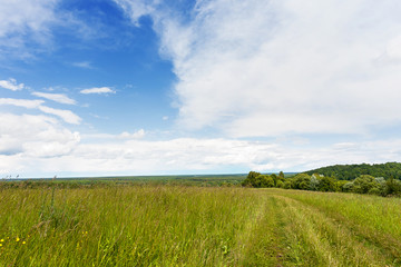 Abstract natural background. Rural path winds along the field. Russia.