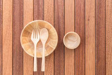 Empty bowl, fork and spoon on wooden table