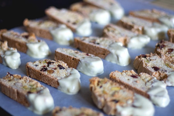 Biscotti pieces dipped in white chocolate. Selective focus.