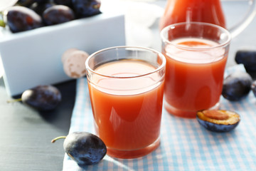 Plum Juice in a glasses with fresh fruits