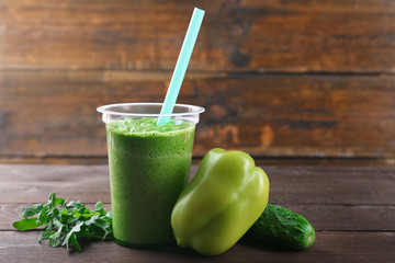 Fresh vegetable juice on wooden background