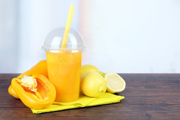 Fresh vegetable juice on wooden table,on bright background