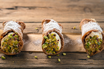 Sicilian cannoli stuffed with ricotta cheese and pistachio, traditional Sicilian dessert, Italian...