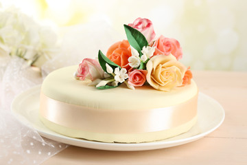 Fototapeta na wymiar Cake with sugar paste flowers, on light background