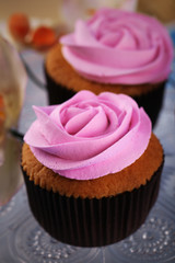 Tasty cupcakes on color wooden background