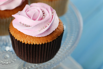 Tasty cupcake on color wooden background