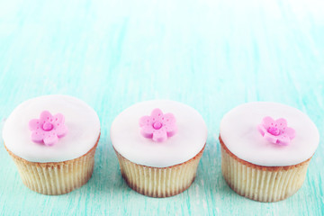 Tasty cupcakes on color wooden background
