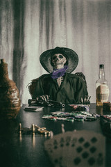 Old West Poker Skeleton Aces and Eights. Old west bandit outlaw skeleton at a poker table with a...