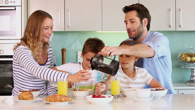 Happy family having breakfast together 