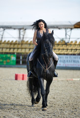 Woman astride a horse