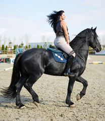 Woman astride a horse