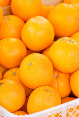 Orange fruit in plastic crate.