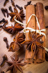 Fototapeta na wymiar Star anise, cinnamon sticks and cloves on wooden table, seasoning for cooking