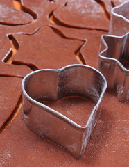 Metal cookie cutters and dough for gingerbread