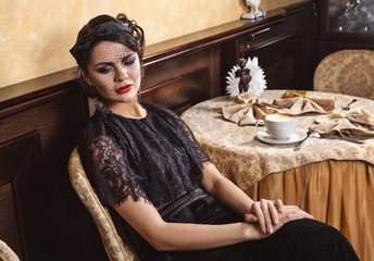 The lady at a table in a cafe.