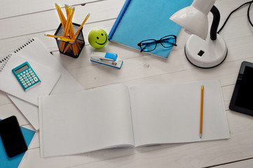 Designer's Desk with tools and open album with blank pages