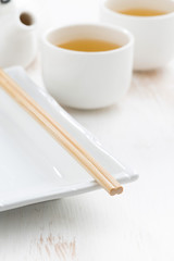 table setting for a Japanese meal on a white wooden background