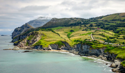 Cantabria landscape with hill, field and abrupt coast of the Atlantic Ocean. Spain.