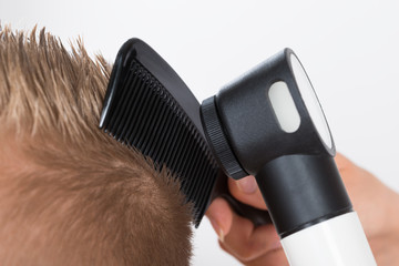 Doctor Examining Patient's Hair Through Dermatoscope