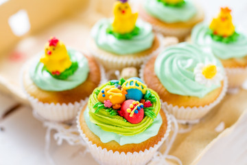 Easter cupcakes on white wood background
