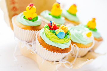 Easter cupcakes on white wood background